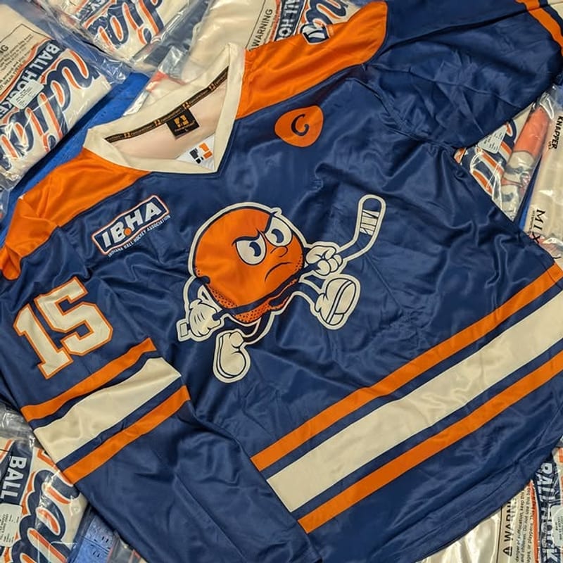 Navy IBHA jersey featuring the orange mascot crest