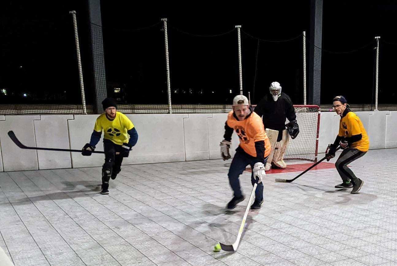 Nighttime ball hockey action on the Indy rooftop rink