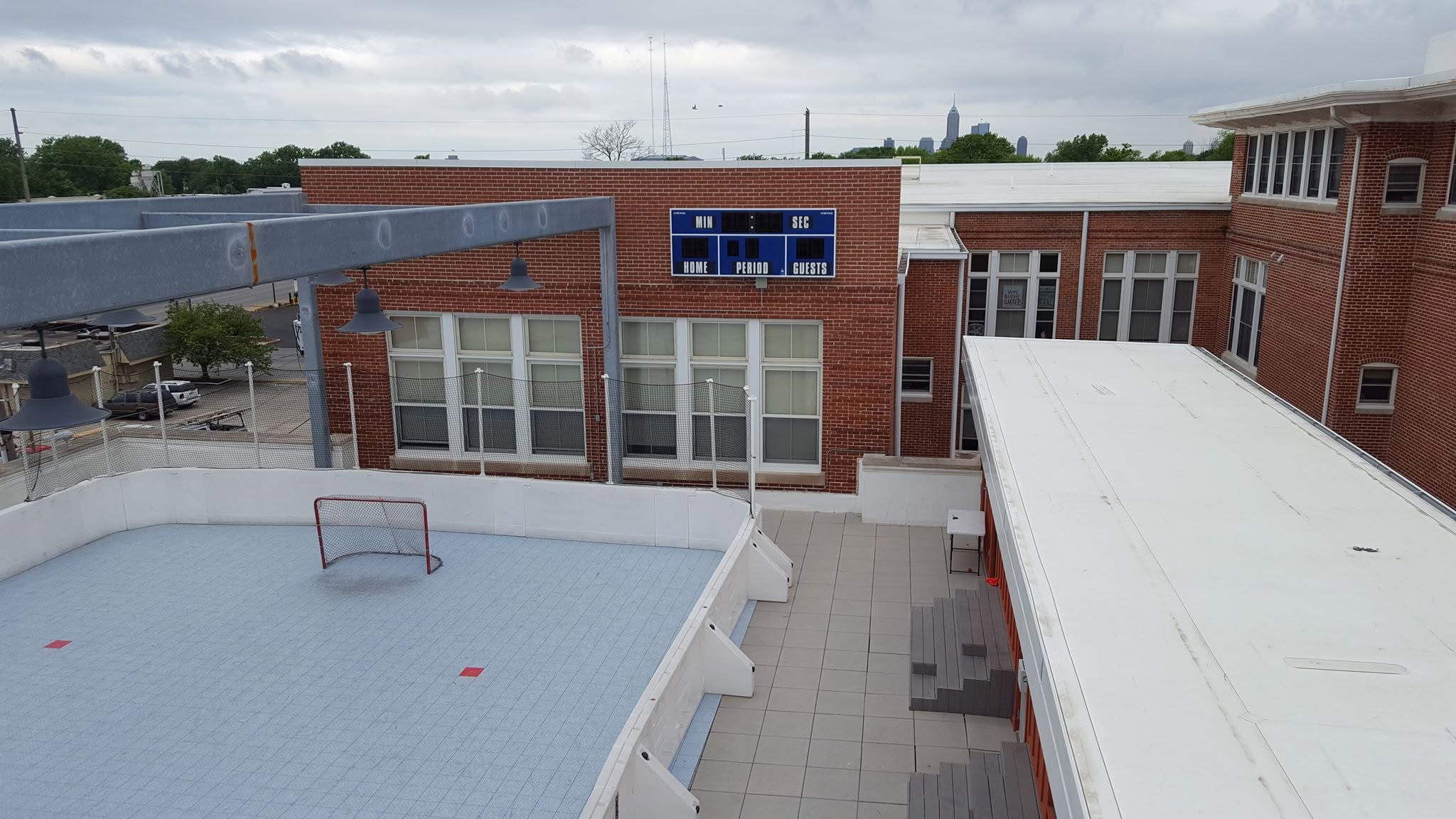 Aerial view of the Indy rooftop ball hockey rink with city skyline